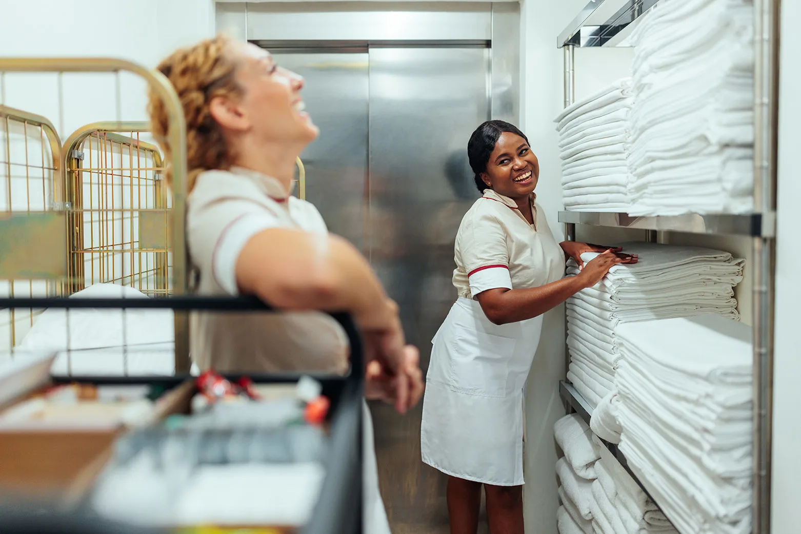 A hospitality worker sorting linens in a laundry facility, representing the diverse UNITE HERE membership served by the Retirement Fund.