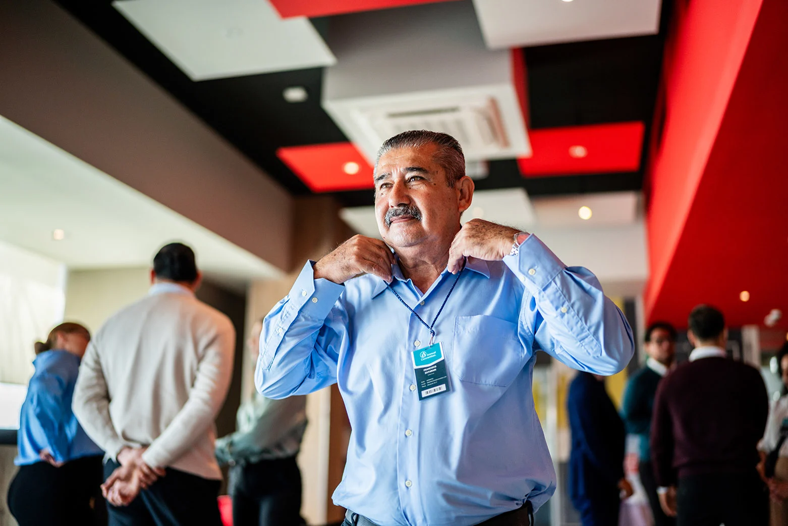 A hotel hospitality worker in professional attire preparing a guest room, representing UNITE HERE Legacy Plan members in the hotel and service industry.